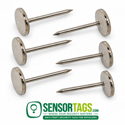 Six smooth flat-head security tag pins arranged in a parallel row, with alternating pointed ends and silver round heads.