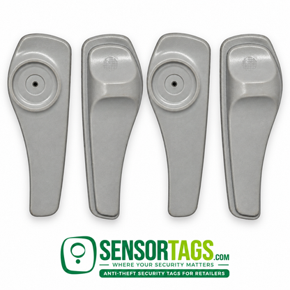Four gray SuperTag II security tags aligned in a row, alternating the circular pin-recess side and the molded back.