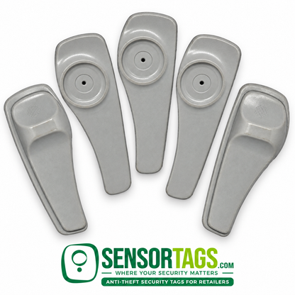 Five gray SuperTag II security tags arranged on white, showing the circular pin recess and shaped back with SensorTags branding.