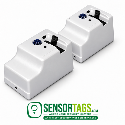 Two refurbished UltraMax electronic tag removers arranged on white, showing their sloped housings, blue domes and black tag cradles.